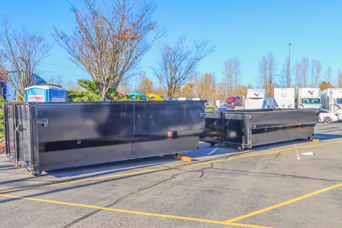 Professional dumpster rental service with roll-off container on residential driveway in Davison